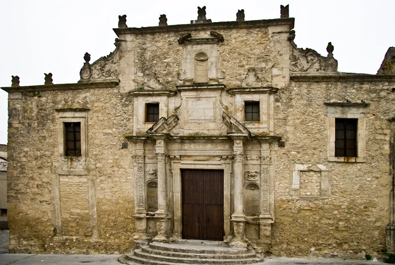 The stone facade of the Collegiate Church of SS. Salvatore in Agira.